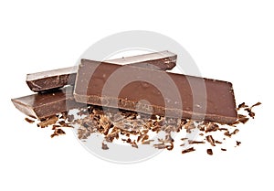 Heap of chocolate shavings and slices on white background
