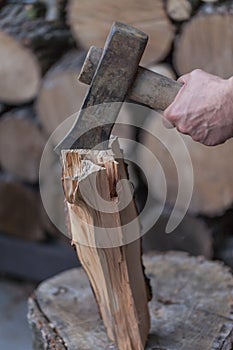 Heap of chopped wood, close up on the axe, cutting firewood and preparing winter wood