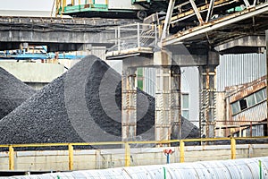 Heap of coal in the mine among mining infrastructure