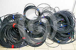 Heap of coiled wires close-up. Powerful trunk cables wound in a circle