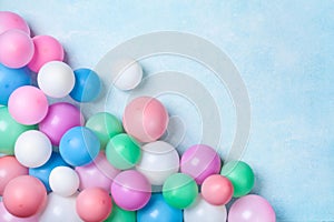 Heap of colorful balloons on blue table top view. Birthday or party background. Flat lay style. Copy space for text