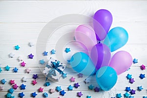 Heap of colorful balloons on white wooden background. Birthday or party background. Flat lay style
