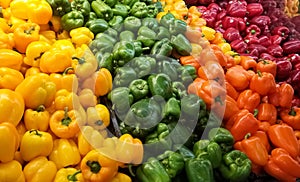 Heap of colorful bell peppers on the shelf of a supermarket or grocery store