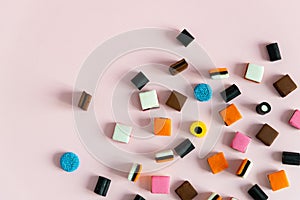 Heap of colorful Liquorice allsorts on pink background