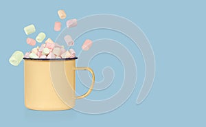 Heap of colorful marshmallows in an enameled mug