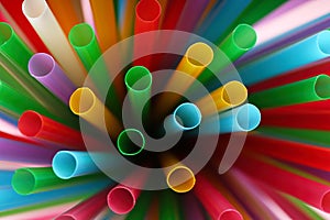 Heap of colorful plastic straws for drinks as background, closeup