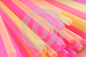 Heap of colorful plastic straws for drinks as background, closeup