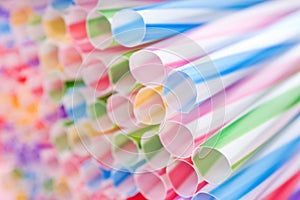 Heap of colorful plastic straws for drinks as background, closeup