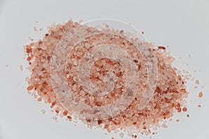 Heap of crystal pink rock Himalayan salt isolated on white background. Close-up