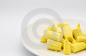 Heap cut baby corn in dish on white background