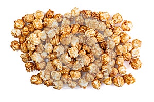 Heap of delicious caramel popcorn, isolated on white background . Scattered popcorn texture background