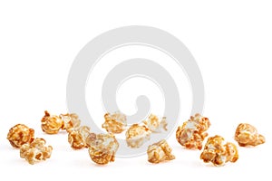 Heap of delicious caramel popcorn, isolated on white background. Scattered popcorn texture background . Selective focus