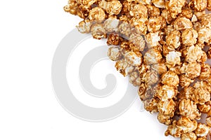 Heap of delicious caramel popcorn, isolated on white background. Scattered popcorn texture background . Selective focus