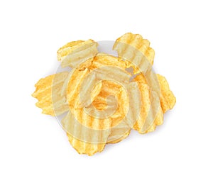 Heap of delicious ridged potato chips on white background, top view