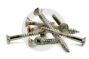 Heap of different cross-head screws isolated on white background