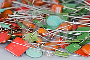 Heap of different fixed capacitors, close-up in selective focus