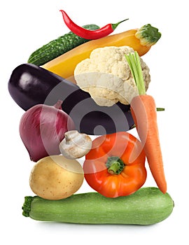 Heap of different fresh vegetables on white