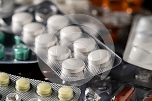 Heap of different pills in blisters pack. Close up of green, yellow, white tablets. Vitamins, painkillers, antibiotics