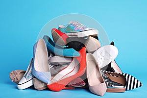 Heap of different shoes on color