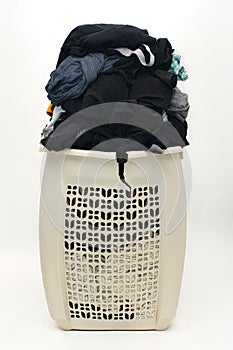 Heap of dirty clothes in busted hamper