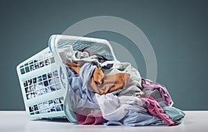 Heap of dirty clothes and laundry basket