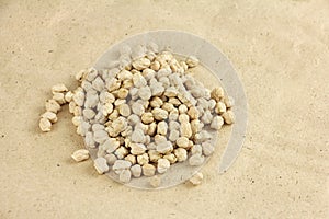 Heap of dried chickpeas on craft paper, chickpea seeds are high in vegetable protein