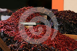 Heap of dried chili peppers on counter at market