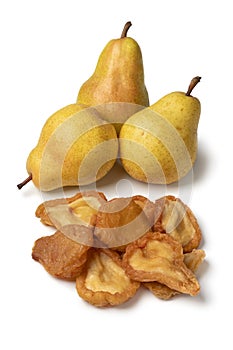 Heap of dried pear fruit and fresh pears close up on white background