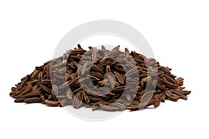 Heap of dry brown cumin or caraway seeds isolated on white background