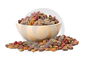 Heap of dry pet food in wooden bowl