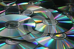 Heap of DVD, CD disks on white