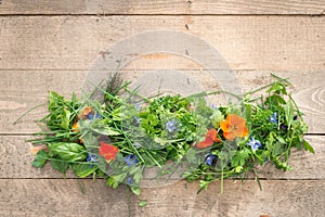 Heap of Edible Flowers and Herbs on Wooden Planks