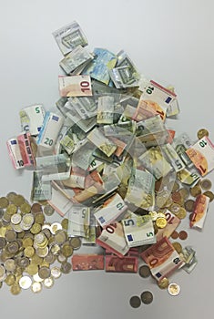 Heap of euro coins and bank notes