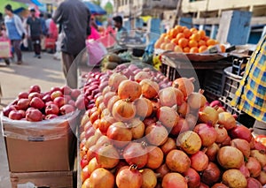 Heap of farm fresh Pomegranates kept on a cart for sale in a Indian fruit market