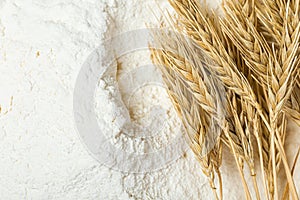 a heap of flour and ears of wheat after sifting. Concept Record prices and high prices for bakery products. Rising