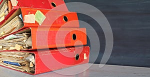 Heap of four ring binders, file folders.Negative space technique, free copy space.
