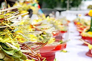 Heap of fragrant flowers with incense on red wooden trays