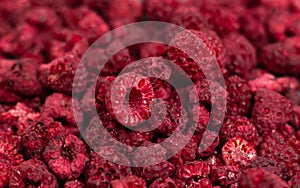 Heap of freeze dried raspberries close-up or dehydrated food background