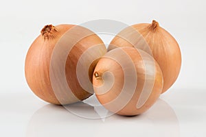 Heap of fresh beige onion bulb on white background.