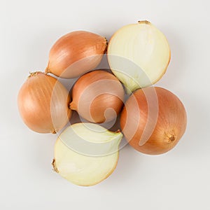 Heap of fresh beige onion bulb on white background.