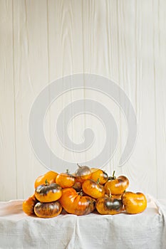 Heap of fresh brown and yellow tomatoes