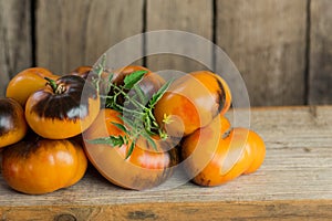 Heap of fresh brown and yellow tomatoes. Tomatoes Alices Dream on the old wooden table