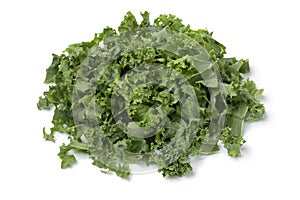 Heap of fresh cut green curly kale close up on white background