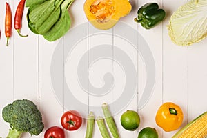 Heap of fresh fruits and vegetables on wooden background