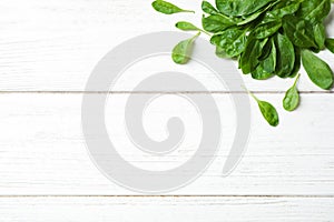 Heap of fresh green healthy spinach on wooden table, top view. Space for text
