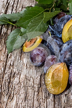 Heap of fresh Plums with leaves