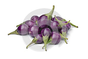 Heap of fresh raw purple mini eggplants photo