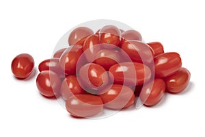 Heap of fresh small red sweet snack tomatoes on white background