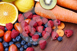 Heap of fresh tropical fruits colorful vegetables summer healthy food / Many ripe fruit mixed on wooden background