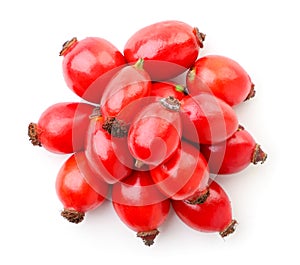 Heap of fresh wild rose berries on white background, isolated. The view from top